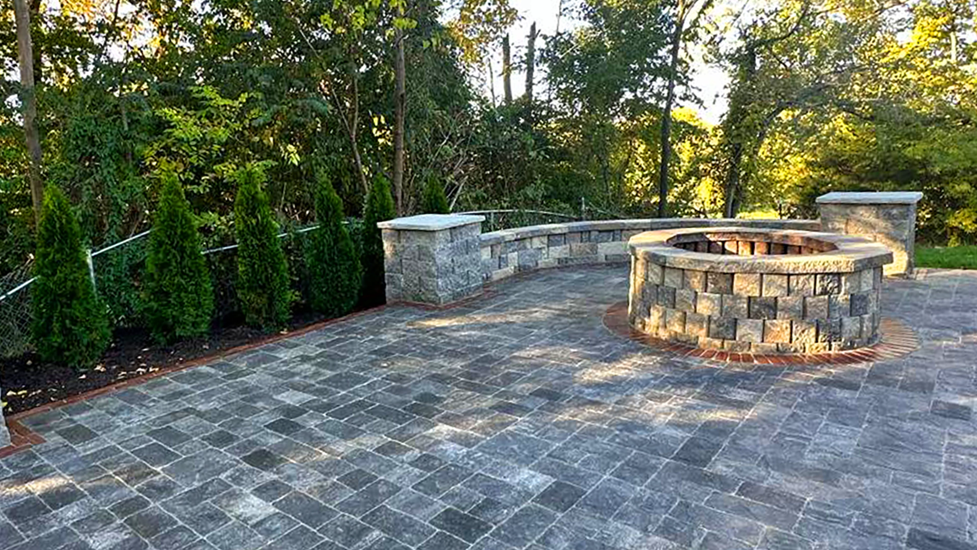 Masonry fire pit on stone patio