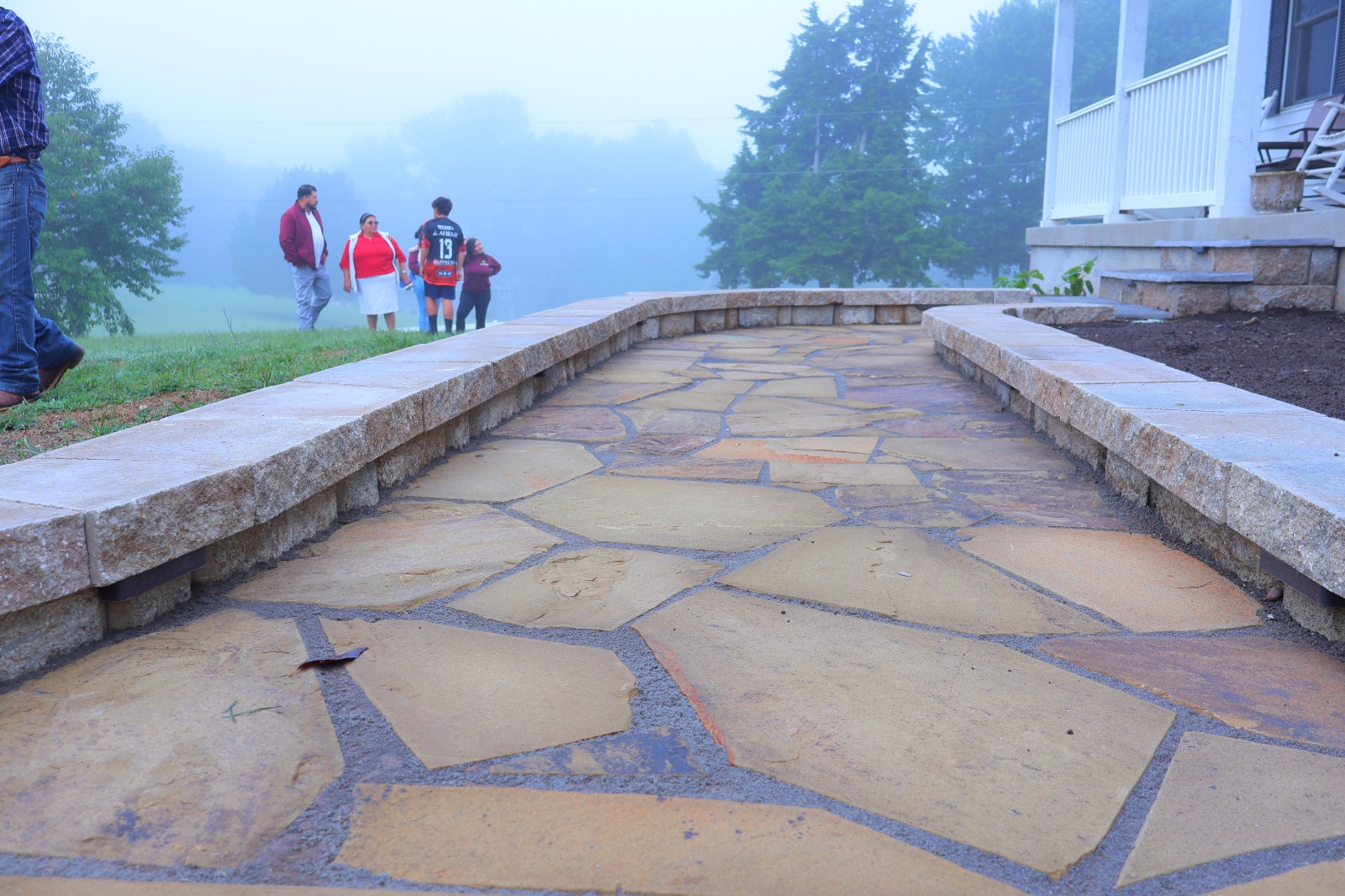 Flagstone walkway with low retaining walls installed by Mountain Landscaping